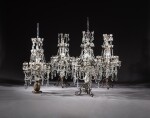 A set of four Régence style bronze and cut-glass twelve-light candelabra | Ensemble de quatre candélabres à douze lumières en bronze et verre taillé de style Régence