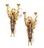 A pair of Louis XVI style patinated and gilt-bronze wall appliques, 19th century