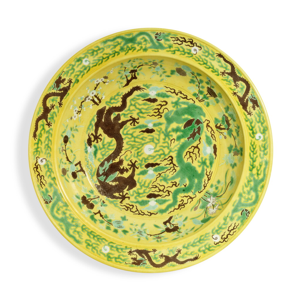 View full screen - View 1 of Lot 557. A massive yellow-ground green- and aubergine-enameled 'Chuxiugong' 'dragon' charger, Qing dynasty, Guangxu period, circa 1889 | 清光緒 約1889年 黃地紫綠彩雲龍趕珠紋大盤 《儲秀宮製》款.