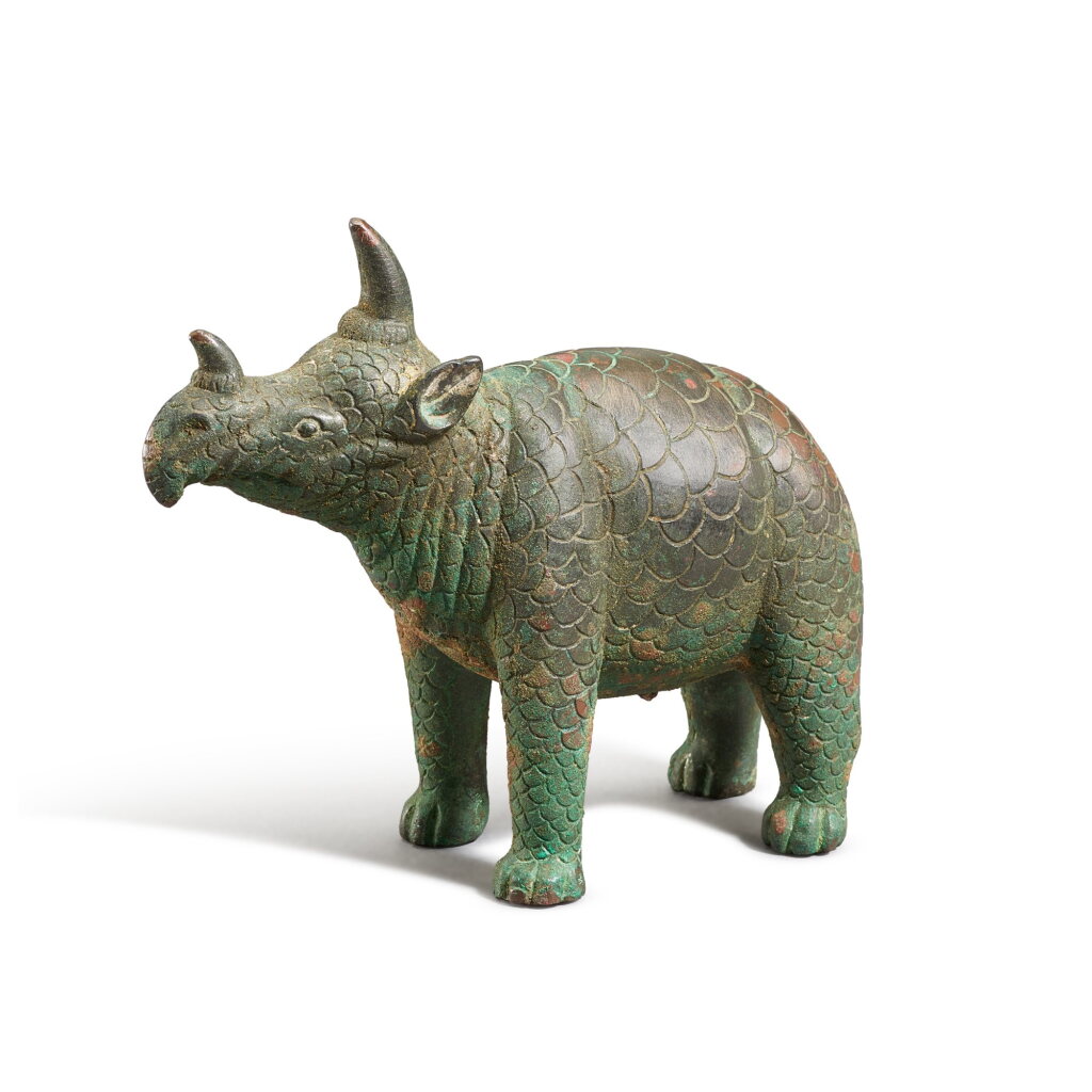 View full screen - View 1 of Lot 3620. A rare small bronze figure of a rhinoceros, Tang dynasty | 唐 青銅犀牛.