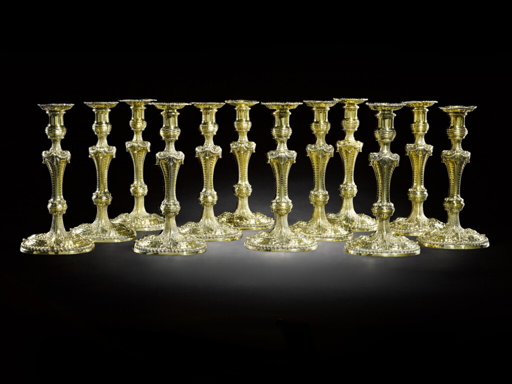View full screen - View 1 of Lot 15. Royal: A set of twelve silver-gilt candlesticks, two William Solomon, London, 1753; eight Thomas Pitts II and two John Mewburn, London, 1806.