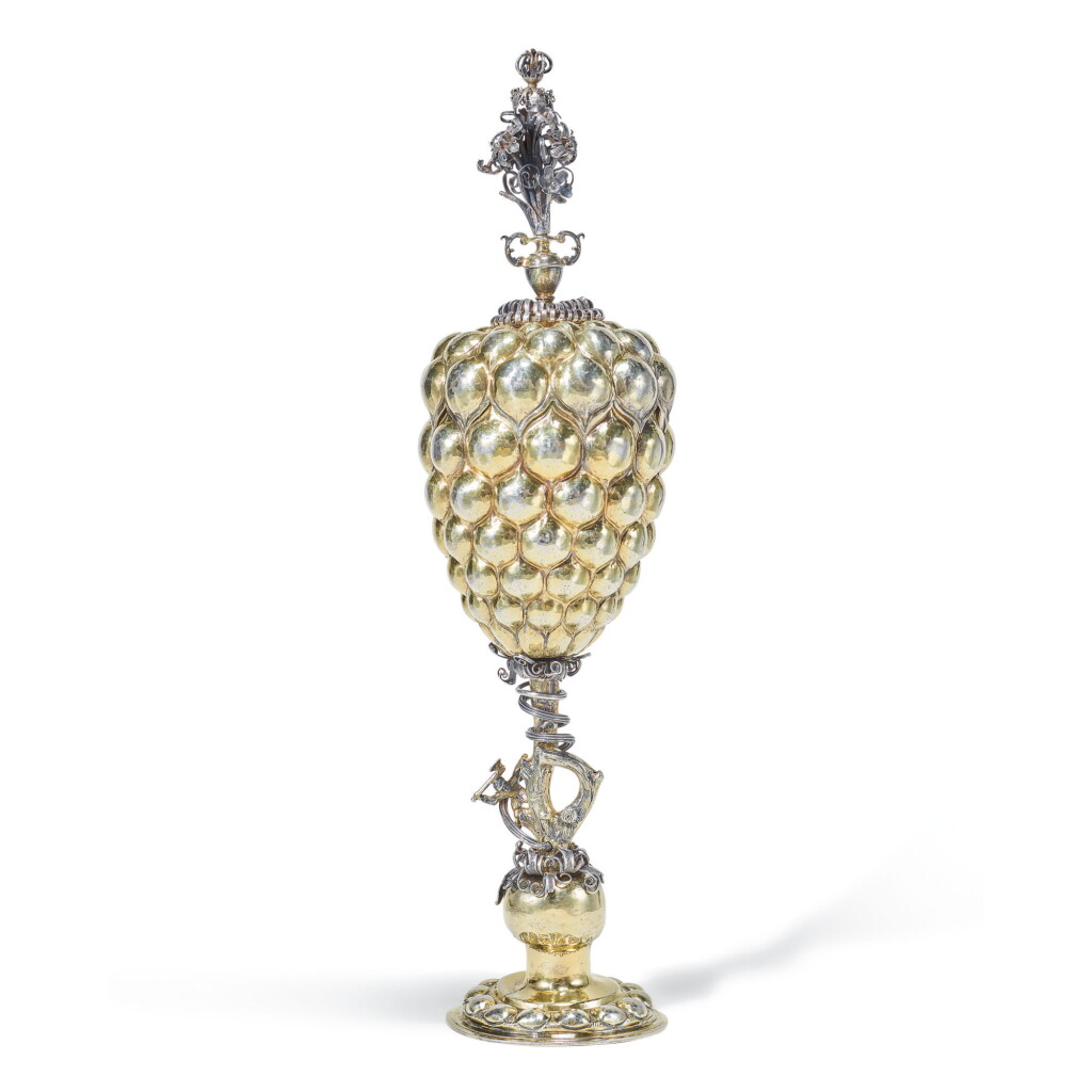 View full screen - View 1 of Lot 73. A TALL GERMAN SILVER-GILT COVERED CUP (TRAUBENPOKAL), ESAIAS ZUR LINDEN, NUREMBERG, CIRCA 1610.