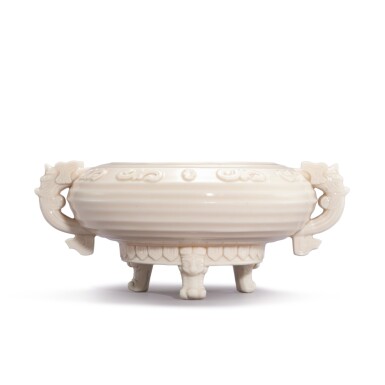 View full screen - View 1 of Lot 9350. A blanc-de-Chine archaistic 'mask' incense burner, 17th century | 十七世紀 德化白瓷仿古貼卷草紋雙龍耳簋式爐.