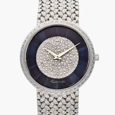 View full screen - View 1 of Lot 700. Reference 12343 D 2 | A white gold and diamond-set automatic bracelet watch with hawk's eye dial, Circa 1970.
