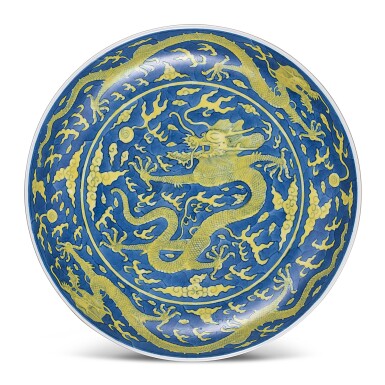 View full screen - View 1 of Lot 448. A LARGE BLUE-GROUND AND YELLOW-ENAMELLED 'DRAGON' DISH SEAL MARK AND PERIOD OF DAOGUANG | 清道光 藍地黃彩戲珠龍紋盤 《大清道光年製》款.