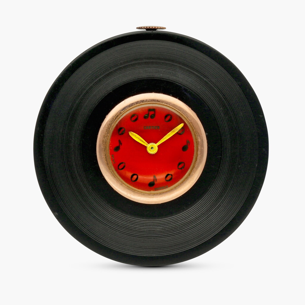 View full screen - View 1 of Lot 2140. A very rare and highly unusual pink gold and Galalith novelty watch in the form of a phonograph record, Circa 1938.