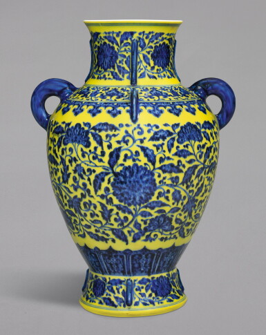 View full screen - View 1 of Lot 27. A RARE YELLOW-GROUND UNDERGLAZE-BLUE 'LOTUS' ARCHAISTIC VASE, QIANLONG SEAL MARK AND PERIOD | 清乾隆 黃地青花纏枝蓮紋出戟雙耳瓶 《大清乾隆年製》款.