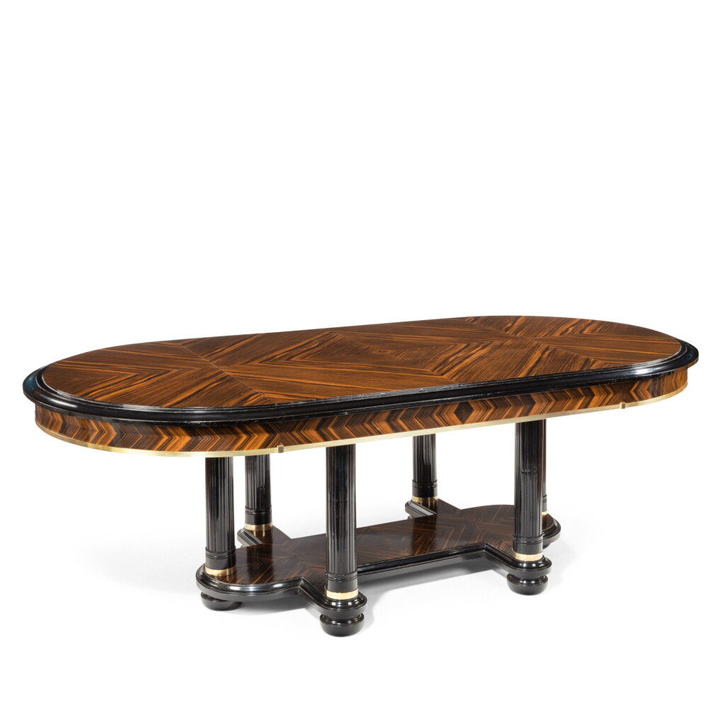 View full screen - View 1 of Lot 54. AN ART DECO STYE BRASS MOUNTED EBONY AND ZEBRA WOOD DINING TABLE, 20TH CENTURY.