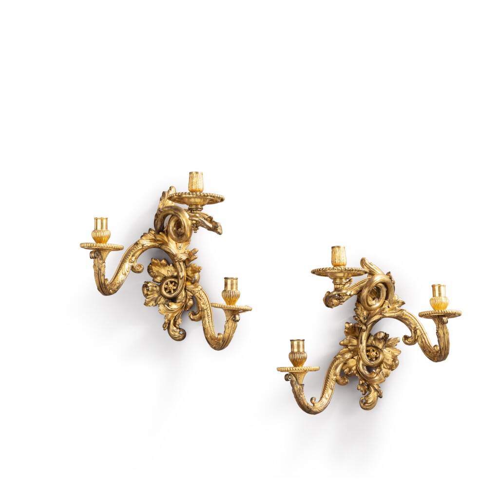 View full screen - View 1 of Lot 412. A pair of Régence gilt-bronze three-light wall appliques, circa 1715 and later, attributed to the workshop of André-Charles Boulle.