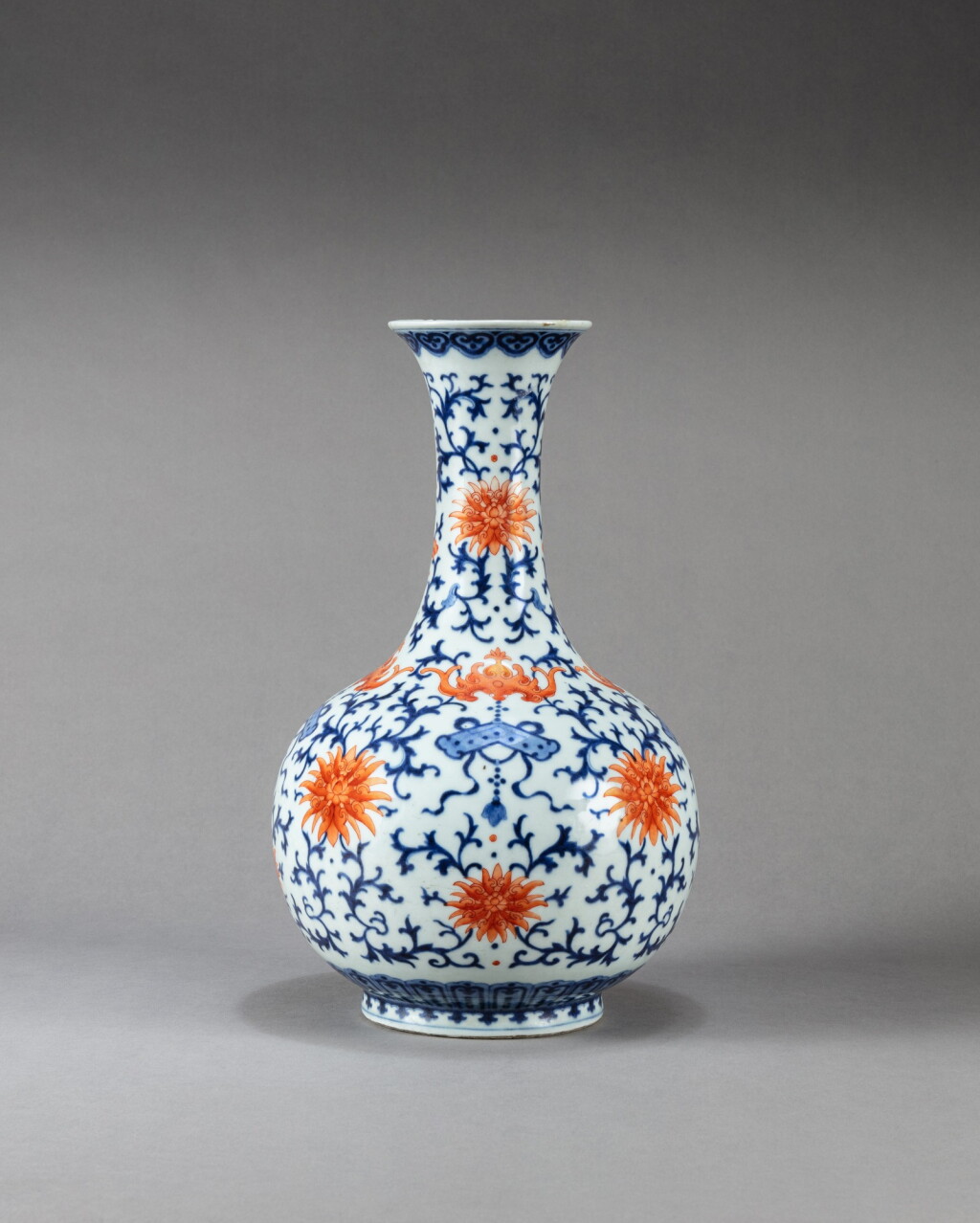 View full screen - View 1 of Lot 213. A blue and white and iron-red 'lotus' vase Qing dynasty, late 18th or early 19th century | 清十八世紀末或十九世紀初 青花礬紅彩蝠蓮紋賞瓶.