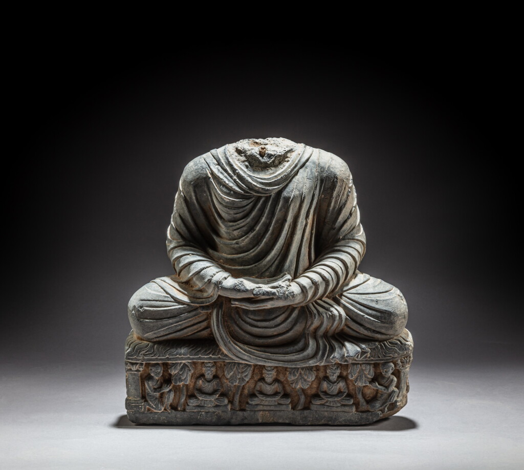 View full screen - View 1 of Lot 102. A gray schist headless figure of Dhyana Buddha, Ancient region of Gandhara, circa 2nd / 4th century | 犍陀羅 約二 / 四世紀 灰片岩雕佛坐像.