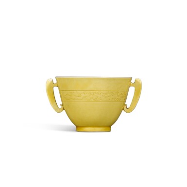 View full screen - View 1 of Lot 1. A yellow-glazed handled cup, Mark and period of Kangxi | 清康熙 黃釉暗刻龍紋耳盃 《大清康熙年製》款 .