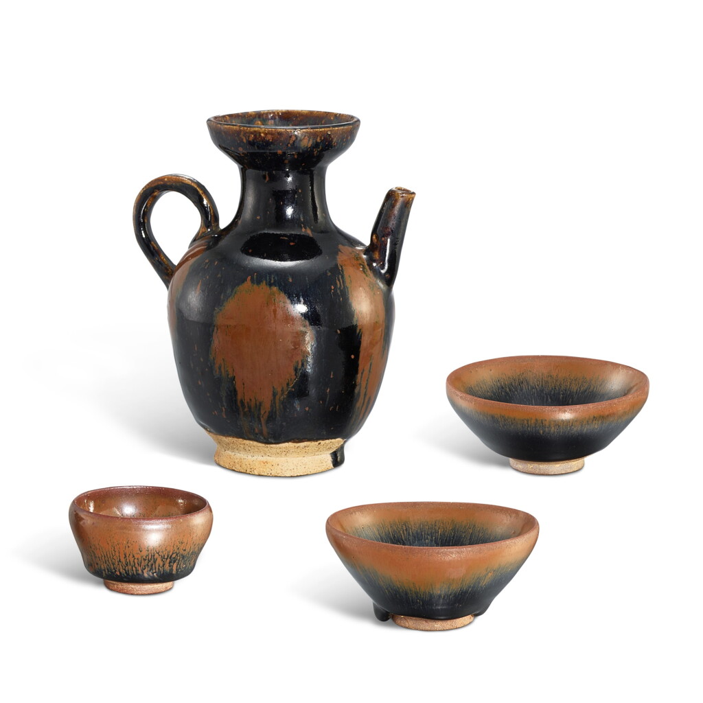 View full screen - View 1 of Lot 363. Three Jian black-glazed tenmoku teabowls and a Henan black-glazed russet-splashed ewer, Song dynasty 宋 建窰黑釉天目茶盞三件及河南黑釉鏽斑執壺一件.