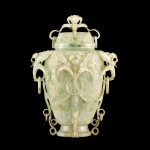 A Mughal style jadeite 'orchid' vase and cover | 翠玉雕痕都斯坦式纏枝蘭花活環耳蓋瓶