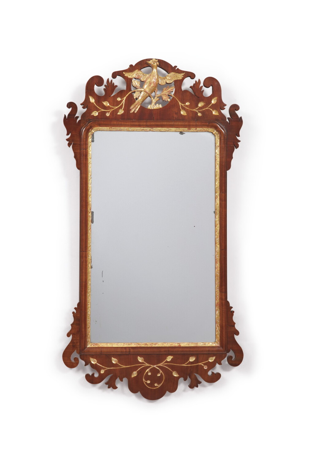 View full screen - View 1 of Lot 85. A GEORGE II PARCEL-GILT, CARVED, AND FIGURED MAHOGANY LOOKING GLASS, CIRCA 1750.
