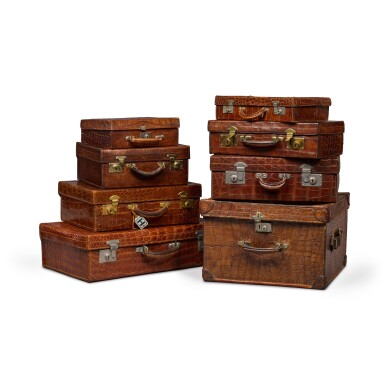 View full screen - View 1 of Lot 114. An impressive matched set of eight Vintage crocodile skin cases in graduated sizes, first quarter 20th century.