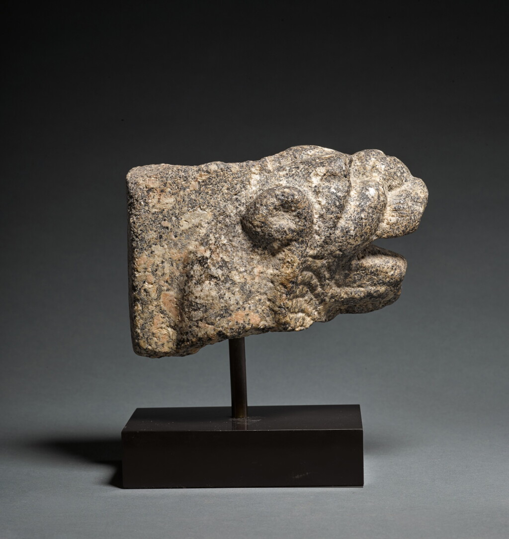 View full screen - View 1 of Lot 10. A Granite Feline Head Terminal from a Trapezophoros (Table Leg), Roman Egypt, circa 2nd Century A.D..