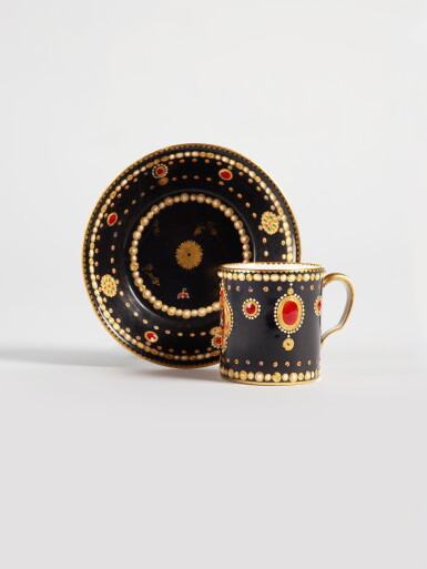 View full screen - View 1 of Lot 343. A Sèvres Porcelain 'Jeweled' Black-Ground 'Dauphin' Cup and Saucer (Gobelet litron et soucoupe), circa 1781.