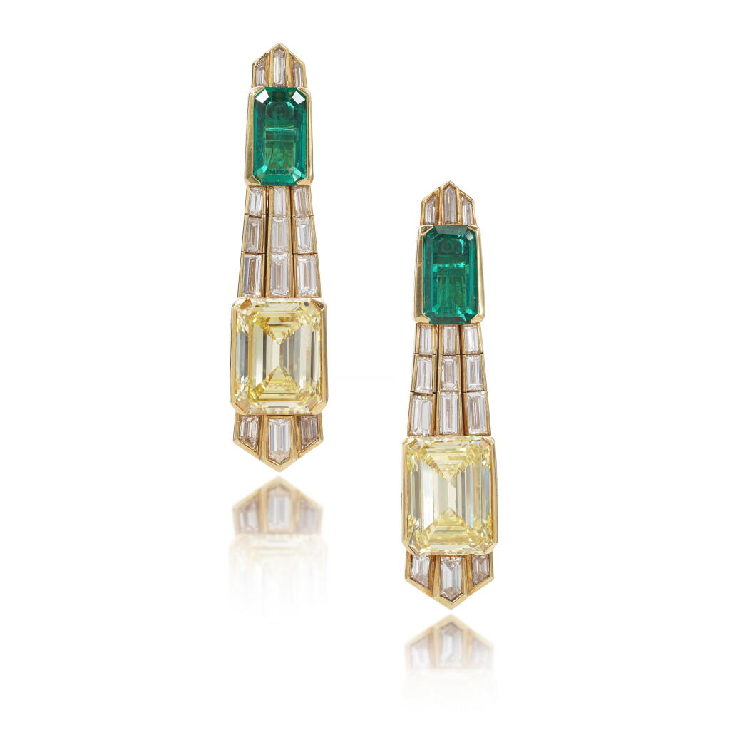 View full screen - View 1 of Lot 571. Impressive pair of Fancy Intense Yellow diamond, emerald and diamond pendent earrings, circa 1979.