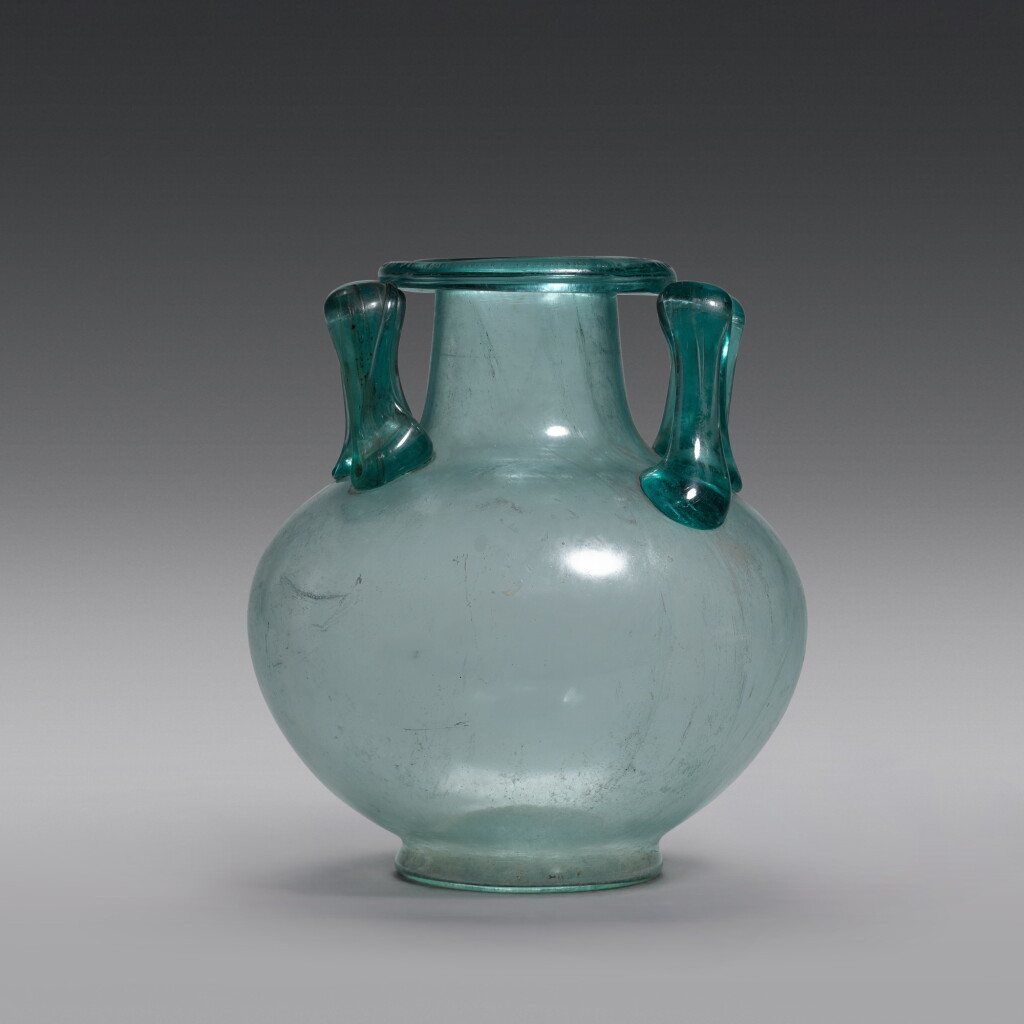 View full screen - View 1 of Lot 37. A Roman Blue-green Glass Cinerarium, circa 1st/2nd Century A.D..
