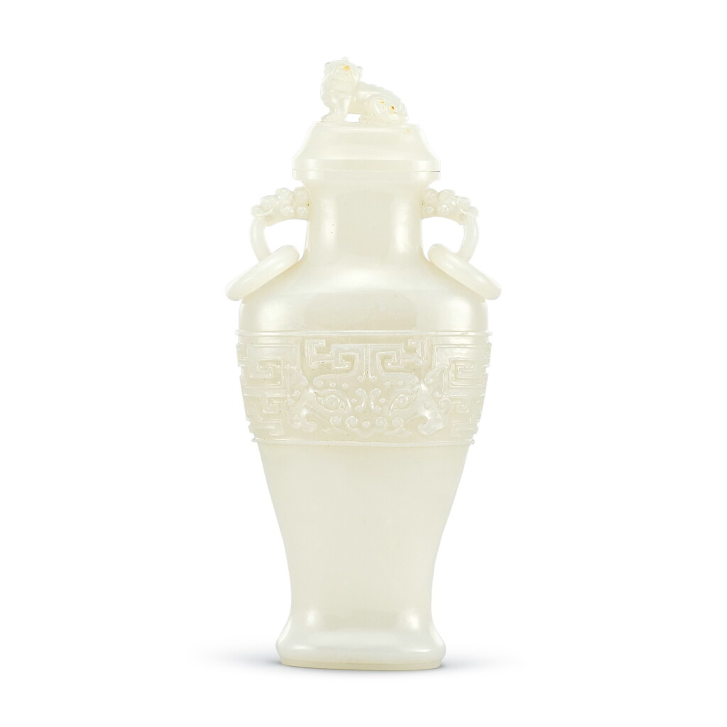 View full screen - View 1 of Lot 318. A white jade archaistic vase and cover, Qing dynasty | 清 白玉仿古活環龍耳蓋瓶.