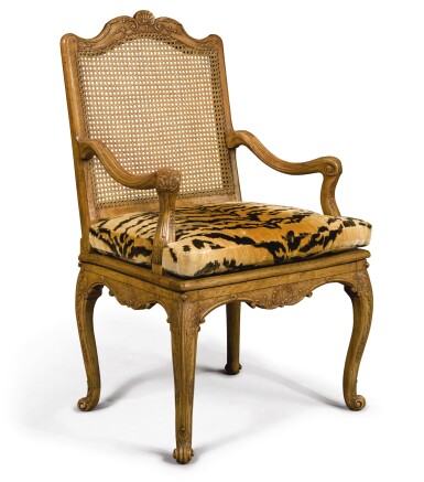 View full screen - View 1 of Lot 752. A REGENCE CARVED BEECHWOOD AND CANED FAUTEUIL, Circa 1720.