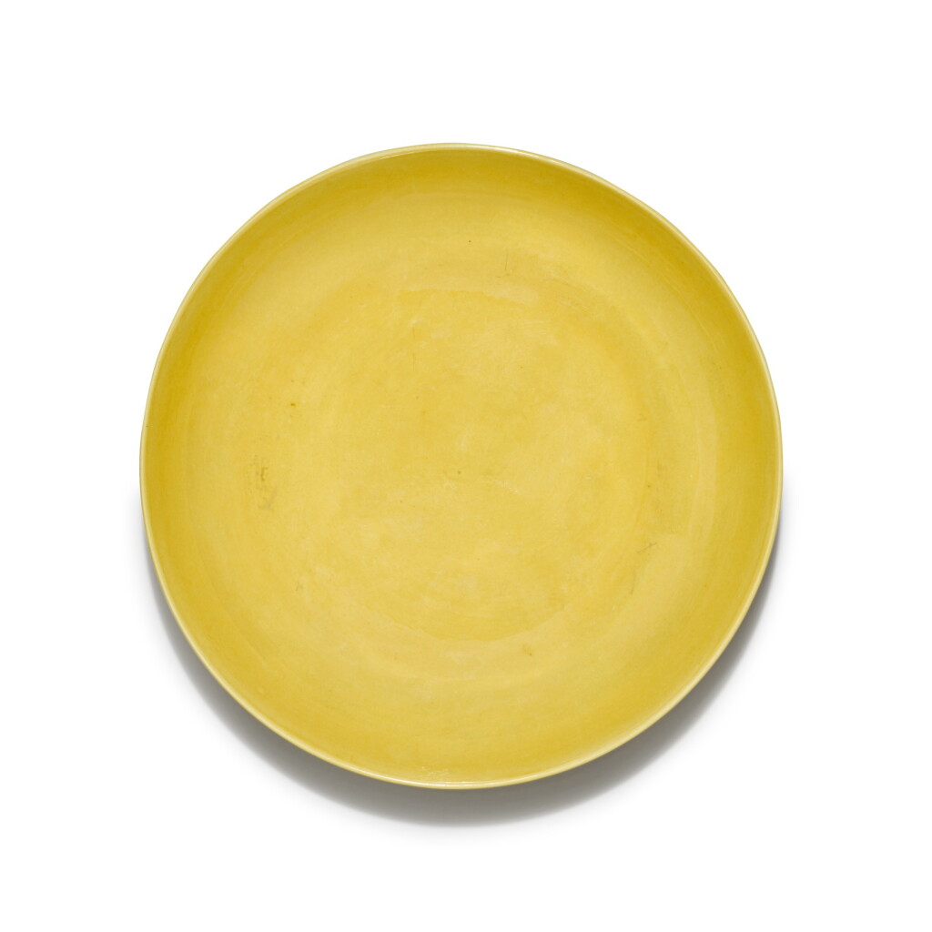 View full screen - View 1 of Lot 5. A yellow-glazed 'lotus' dish, Mark and period of Yongzheng | 清雍正 黃釉刻蓮紋盤 《大清雍正年製》款.