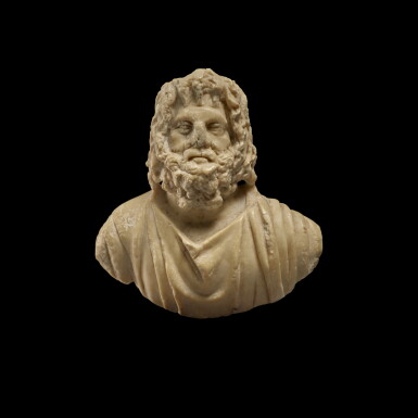 View full screen - View 1 of Lot 268. A Roman Marble or Indurated Limestone Appliqué Bust of Zeus-Serapis, circa 2nd Century A.D..