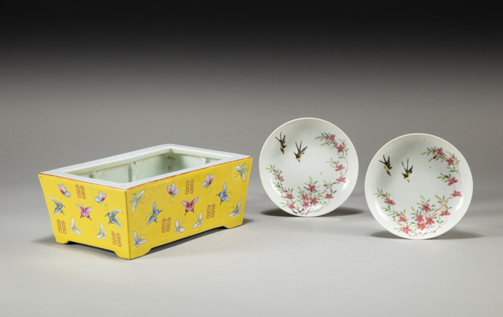 View full screen - View 1 of Lot 136. A yellow-ground famille-rose jardinière and two famille-rose saucers, Late Qing dynasty | 清晚期 黃地粉彩百蝶囍字紋盆 及 粉彩花鳥纹小盤一對.