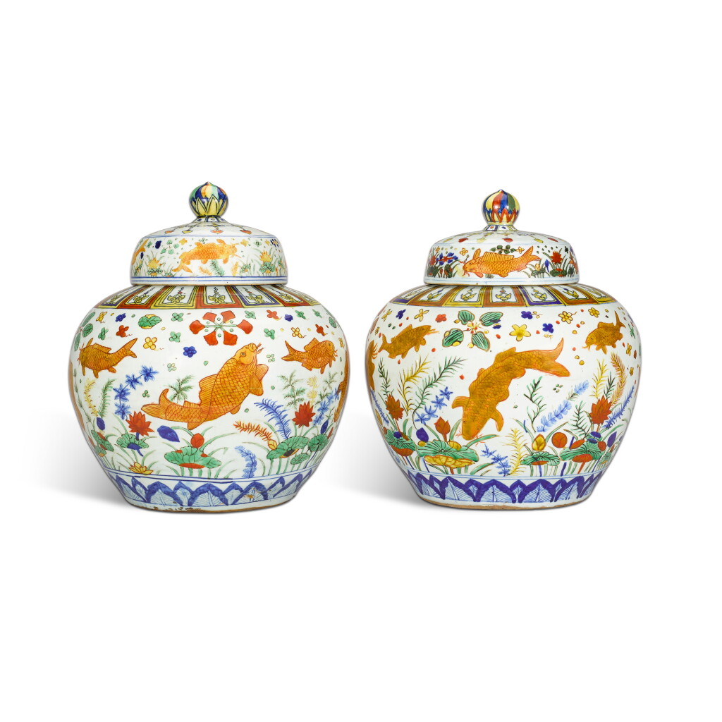 View full screen - View 1 of Lot 32. An exceptionally rare and magnificent pair of wucai 'fish' jars and covers, Marks and period of Jiajing.