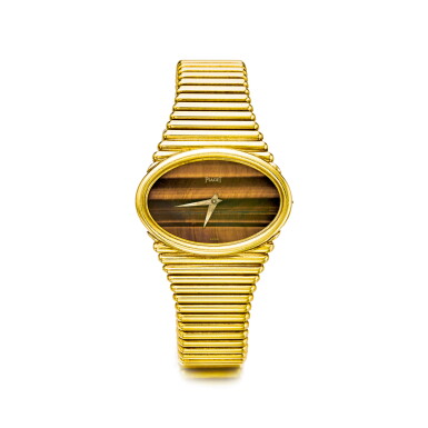 View full screen - View 1 of Lot 839. PIAGET | REF 9850 C 10, A YELLOW GOLD BRACELET WATCH WITH TIGER'S EYE DIAL, CIRCA 1970 | 伯爵 | 9850 C 10型號黃金鍊帶腕錶備貓眼石錶盤,年份約1970.