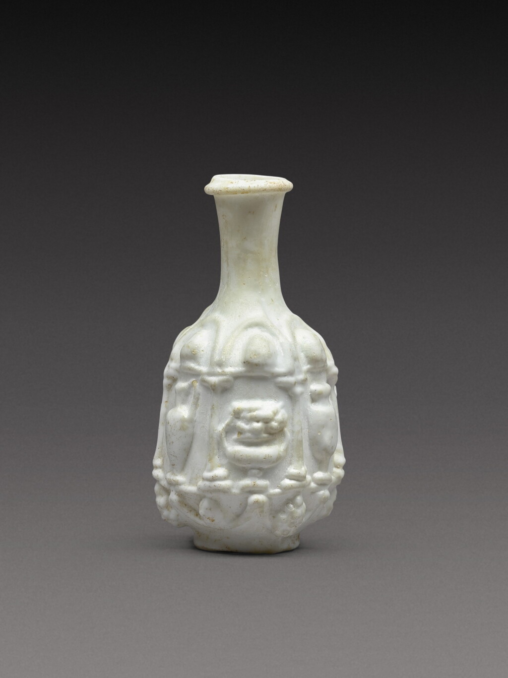 View full screen - View 1 of Lot 7. A Roman Opaque White Mould-Blown Glass Flask, circa 1st century A.D..