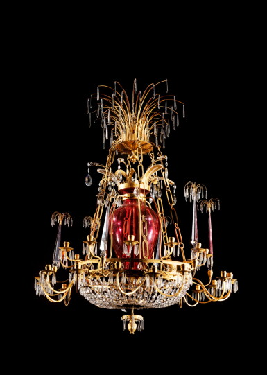 View full screen - View 1 of Lot 326. A large neoclassical gilt-bronze cut-crystal and red glass thirty-light chandelier | Grand lustre à trente lumières en cristal, verre rouge et bronze néoclassique.