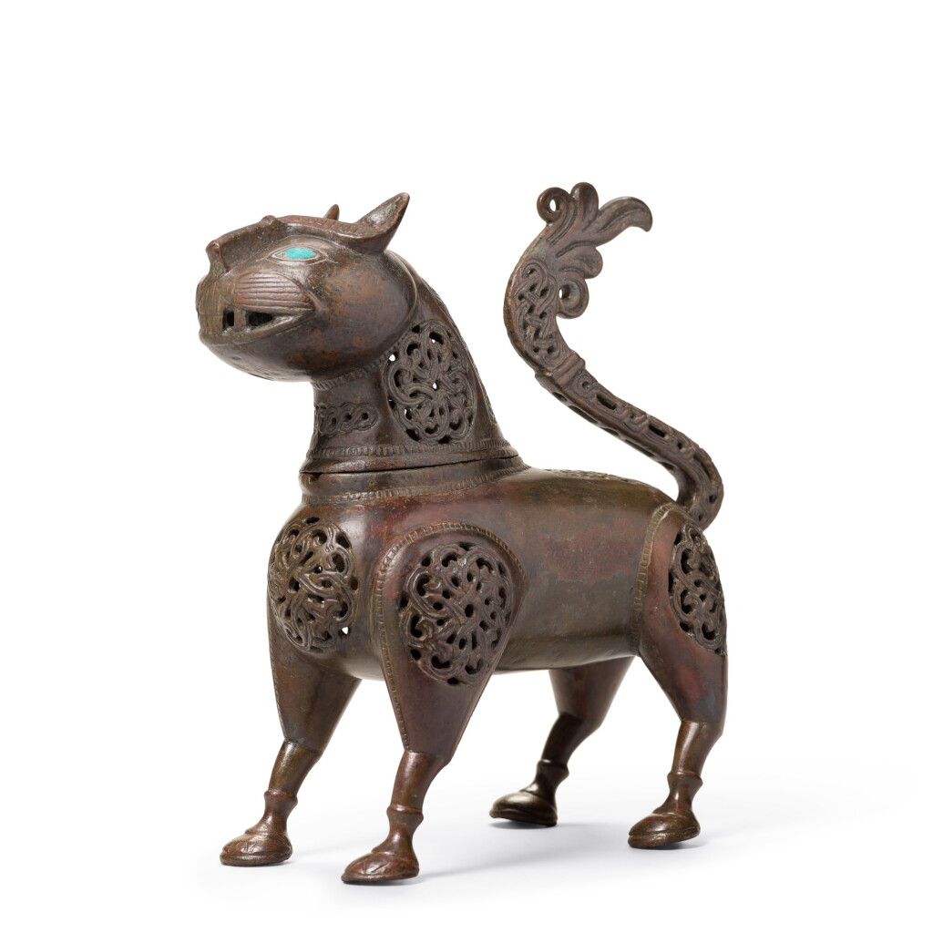 View full screen - View 1 of Lot 133. A Khurasan bronze feline-form incense burner, Persia, 12th century.