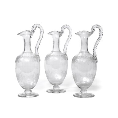 View full screen - View 1 of Lot 120. A SET OF THREE VICTORIAN ENGRAVED GLASS CLARET JUGS, CIRCA 1880.
