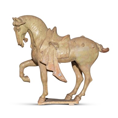 View full screen - View 1 of Lot 24. A straw-glazed pottery figure of a prancing horse, Tang dynasty.