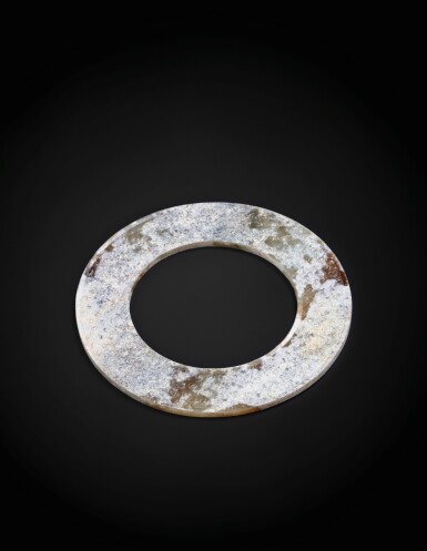 View full screen - View 1 of Lot 34. A partly calcified jade disc, huan Probably Han dynasty | 或為漢 玉環.