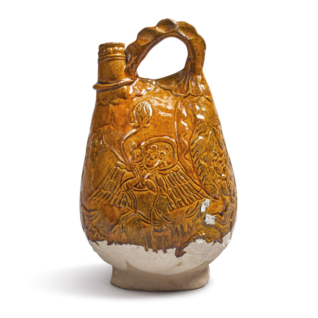 View full screen - View 1 of Lot 695. A RARE MOLDED AMBER-GLAZED 'KALAVINKA' FLASK, LIAO DYNASTY.