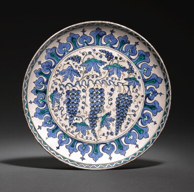 View full screen - View 1 of Lot 273. AN IZNIK POTTERY RIMLESS ‘GRAPE’ DISH, TURKEY, CIRCA 1570-80.