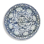 A rare large blue and white moulded 'mandarin duck and lotus pond' dish, Yuan dynasty | 元 青花荷塘鴛鴦紋花口大盤