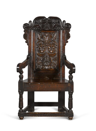 View full screen - View 1 of Lot 24. A Charles II carved oak panel-back armchair.