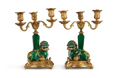 View full screen - View 1 of Lot 303. A PAIR OF GILT BRONZE AND CHINESE PORCELAIN POLYCHROME GLAZED FOO DOG FOUR-LIGHT CANDELABRA, 19TH CENTURY.
