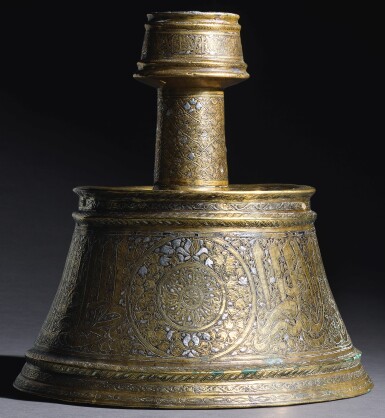 View full screen - View 1 of Lot 99. AN IMPORTANT MAMLUK SILVER-INLAID BRASS CANDLESTICK, EGYPT, LATE 13TH/FIRST HALF 14TH CENTURY .