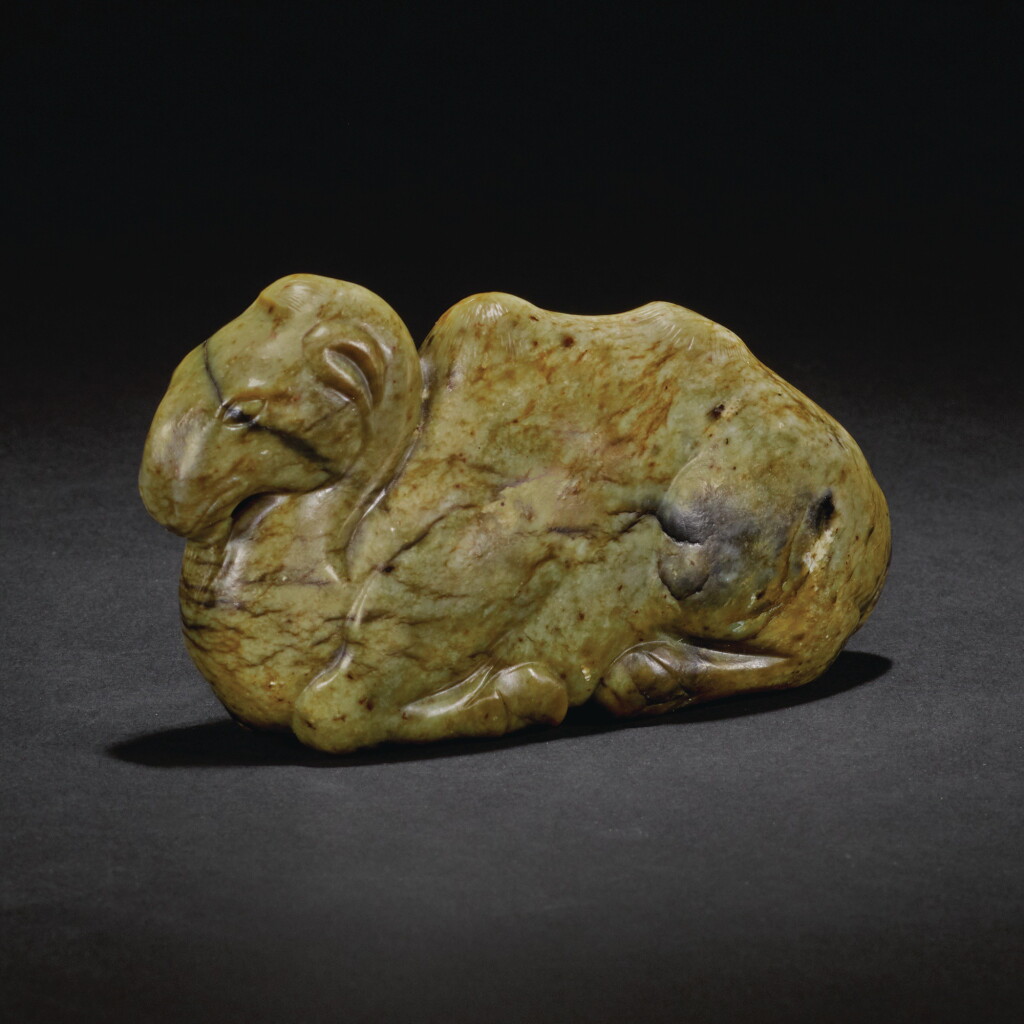 View full screen - View 1 of Lot 145. A RARE MOTTLED JADE FIGURE OF A RECUMBENT BACTRIAN CAMEL, TANG DYNASTY OR LATER | 唐或以後 玉駱駝.