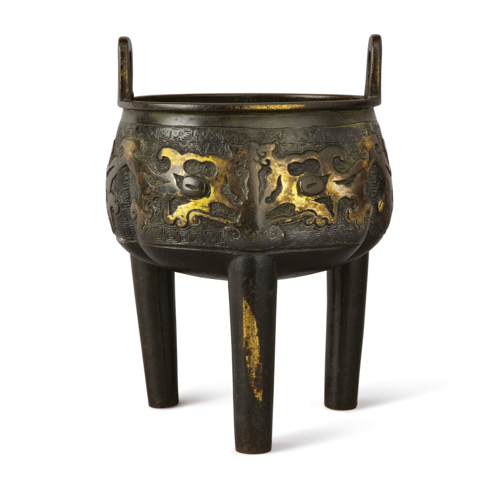 View full screen - View 1 of Lot 620. AN ARCHAISTIC PARCEL-GILT BRONZE TRIPOD CENSER, 17TH CENTURY.