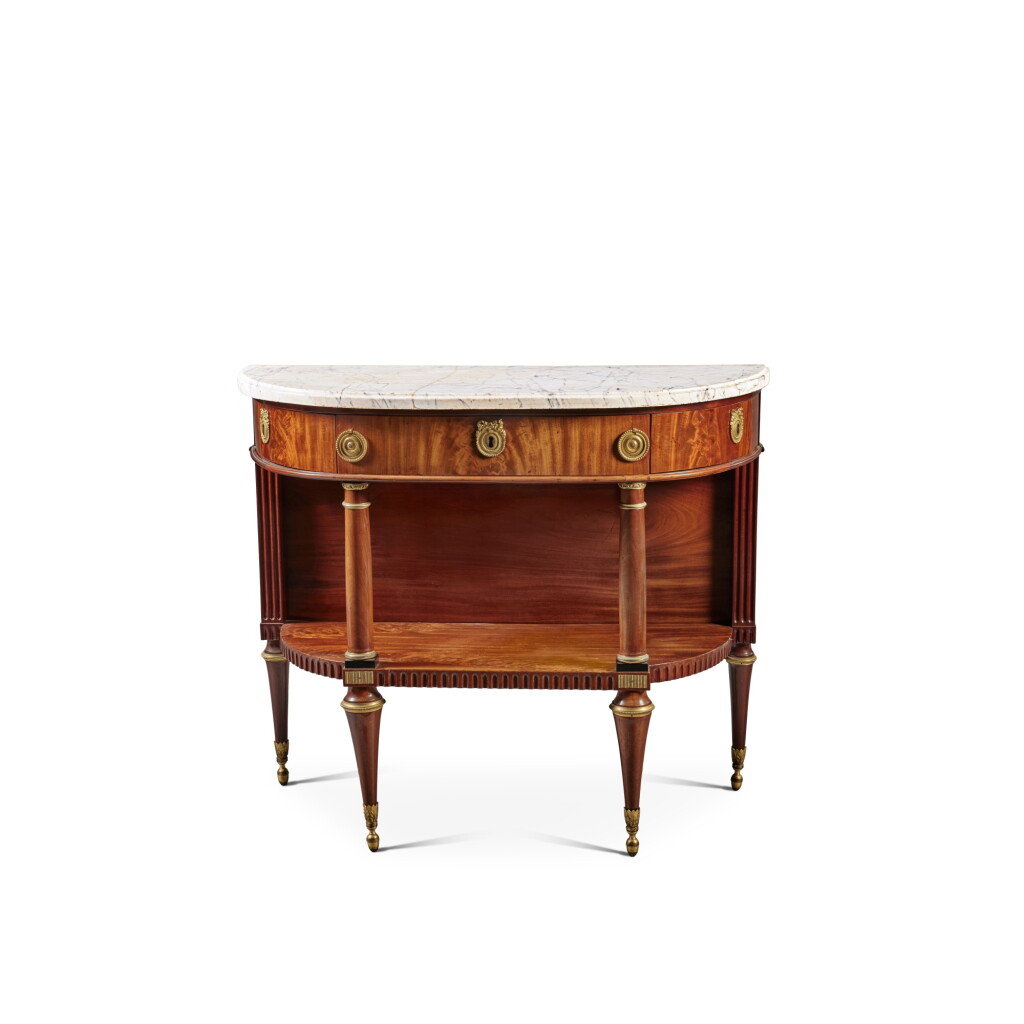 View full screen - View 1 of Lot 653. A Louis XVI Gilt Bronze and Brass Mounted Mahogany Console Desserte by Joseph Feuerstein, Circa 1785.