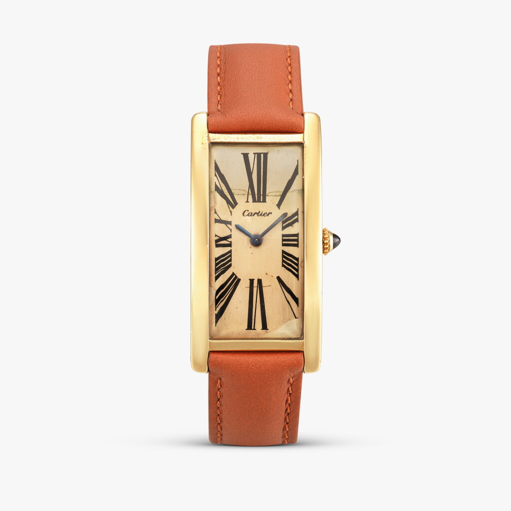 View full screen - View 1 of Lot 2420. Grand Tank Cintrée | A large and impressive yellow gold elongated curved rectangular wristwatch with original gold deployant buckle, Circa 1969-70.
