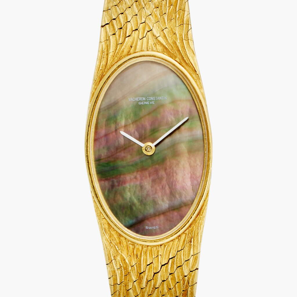 View full screen - View 1 of Lot 53. A yellow gold oval bracelet watch with mother-of-pearl dial, Circa 1960s.