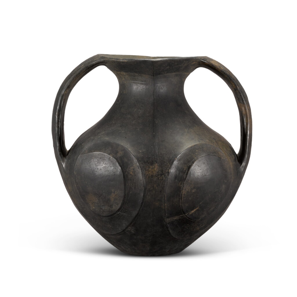 View full screen - View 1 of Lot 18. A Chinese twin-handled black pottery vase, Han dynasty.