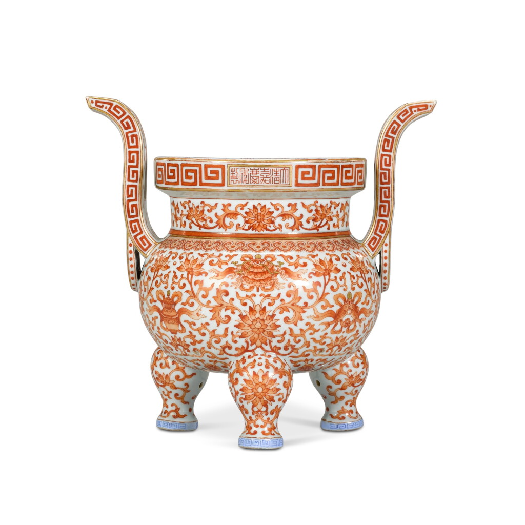 View full screen - View 1 of Lot 24. An iron-red enamelled 'lotus' censer, Seal mark and period of Jiaqing | 清嘉慶 礬紅彩福壽蓮紋三足爐 《大清嘉慶年製》款.
